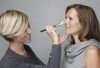 Professional makeup artist Louise Wittlich doing an anti-aging makeup a mature model