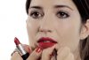 The face of a girl, being made up with deep red lipstick, by makeup artist Louise Wittlich