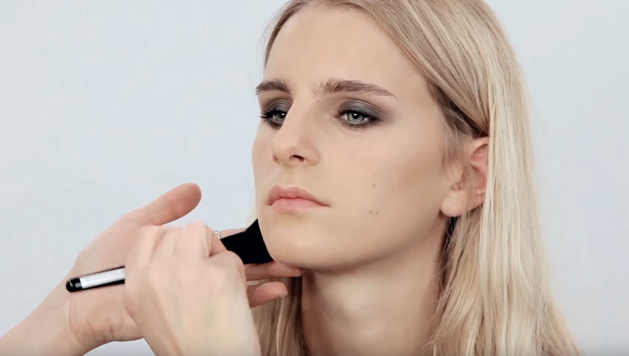 A young woman being made up by Louise Wittlich, withsoftly blended smokey eyes