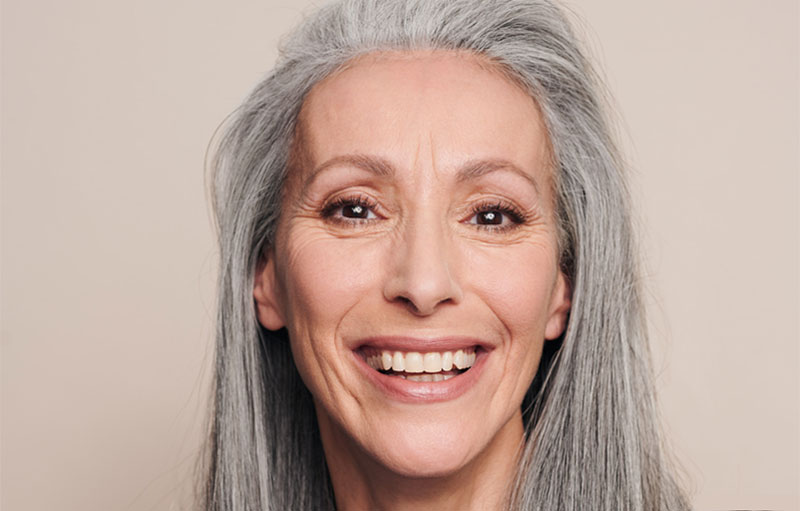 A mature model wearing a beautifully smooth foundation, made up by Louise Wittlich, professional makeup artist and beauty coach