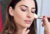 A young women, a wedding guest, is being made up in a natural style.